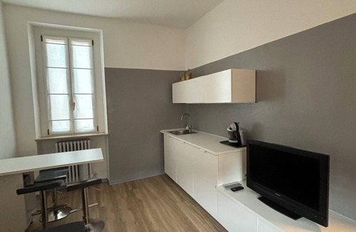 Treviglio Apartment | Apartment with a terrace among the rooftops of an old building.