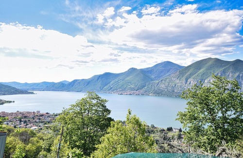 Sovere Apartment | Enjoy the beautiful view of the countryside and this comfortable vacation apartment.