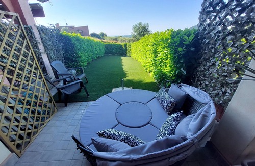 Villanuova sul Clisi Villa | Red villa with shared pool and private garden is the new black on Lake Garda